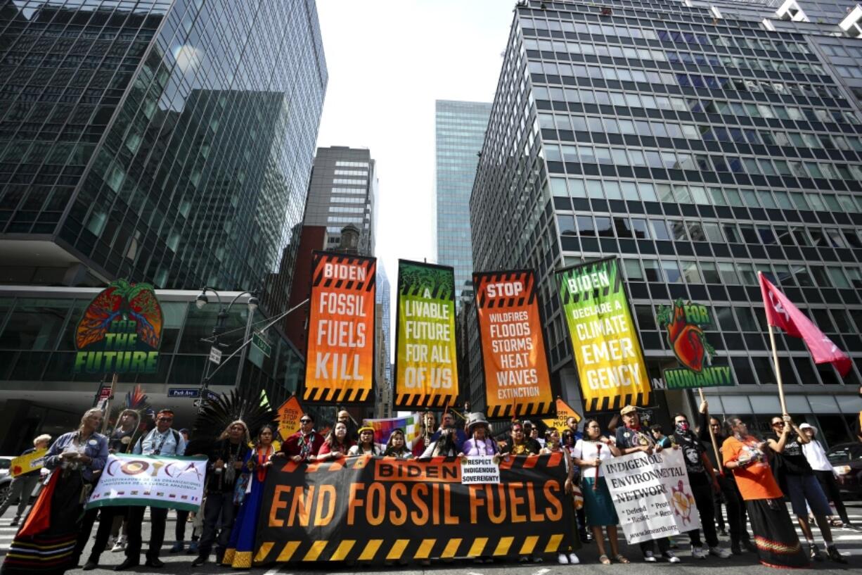 Climate activists block traffic on Park Avenue during a march protesting energy policies and the use of fossil fuels, in New York, Sunday, Sept. 17, 2023.