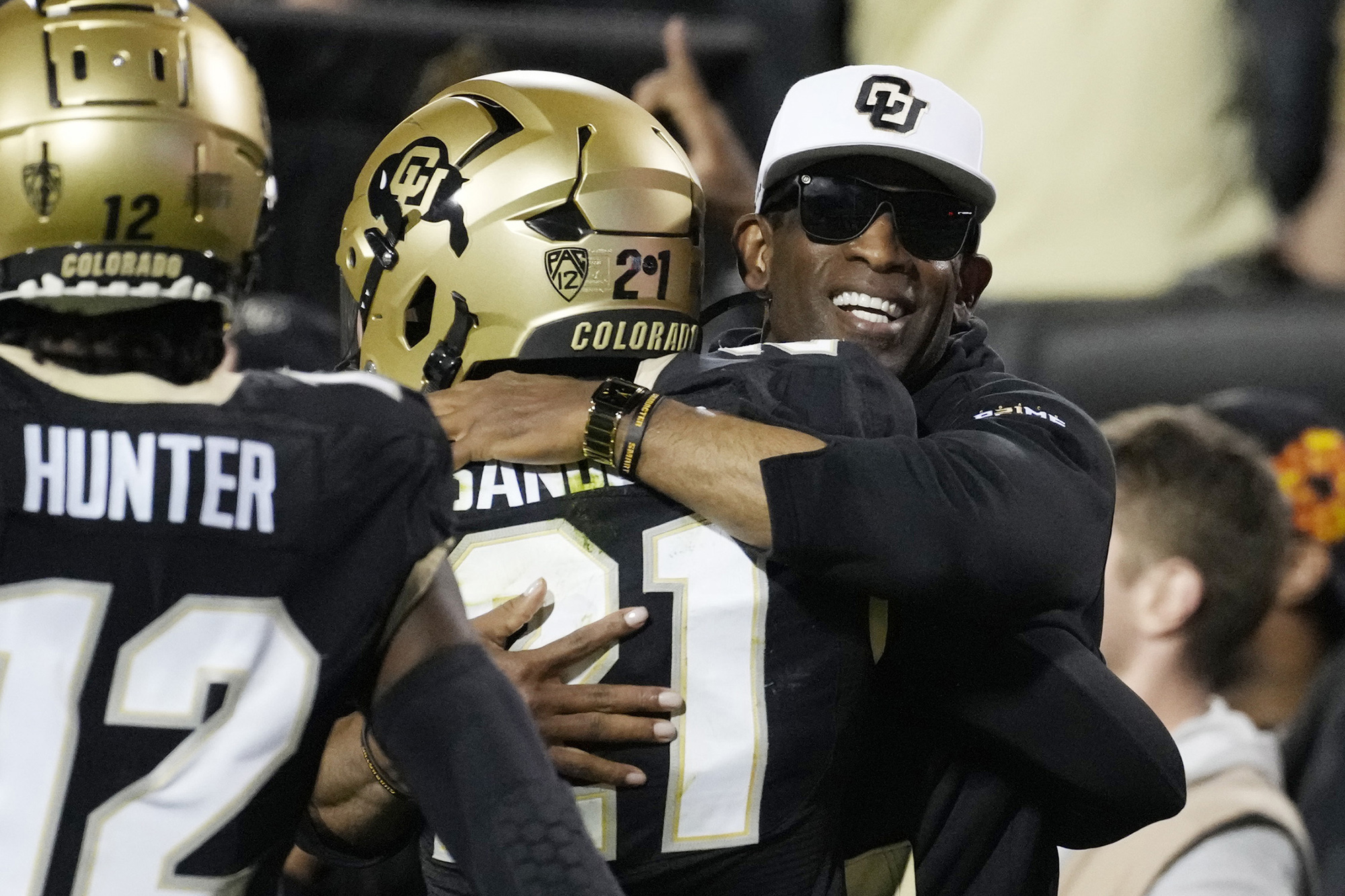 Colorado head coach Deion Sanders, right, hugs his son, safety Shilo Sanders, after he returned an interception for a touchdown in the first half of an NCAA college football game against Colorado State Saturday, Sept. 16, 2023, in Boulder, Colo.