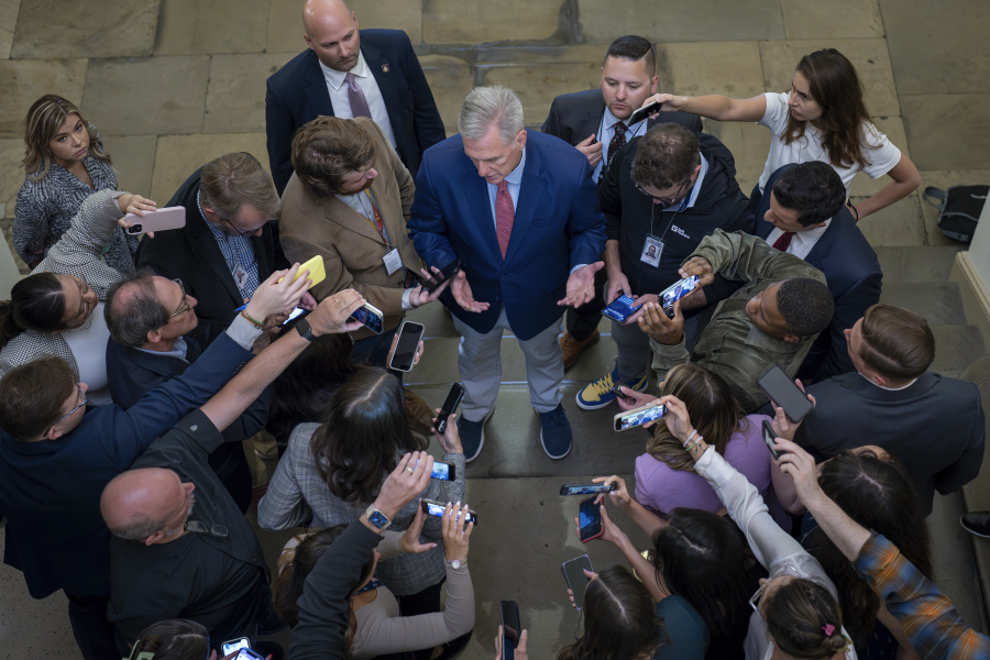 FILE - Speaker of the House Kevin McCarthy, R-Calif., is surrounded by reporters looking for updates on plans to fund the government and avert a shutdown, at the Capitol in Washington, Friday, Sept. 22, 2023. (AP Photo/J.