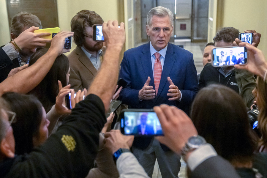 Speaker of the House Kevin McCarthy, R-Calif., is surrounded by reporters looking for updates on plans to fund the government and avert a shutdown, at the Capitol in Washington, Friday, Sept. 22, 2023.