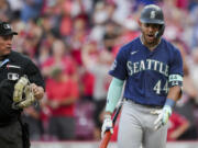Seattle Mariners' Julio Rodriguez, right, reacts to umpire Marvin Hudson, left, after striking out to end a baseball game against the Cincinnati Reds in Cincinnati, Monday, Sept. 4, 2023.