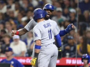 Los Angeles Dodgers' Miguel Rojas (11) celebrates with Jason Heyward after hitting a two-run home run against the Seattle Mariners during the fourth inning of a baseball game Friday, Sept. 15, 2023, in Seattle.