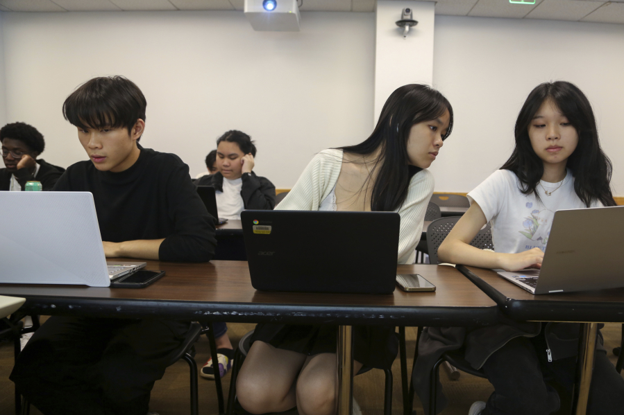 Students, from left, Zhuo Yan Jiang, 18 of Boston Latin School; Shuyi Zheng, 17 of Boston Latin Academy, and Wan Xin Chen, 17 of the John D. O'Bryant School of Mathematics & Science, work during a coding class in the Bridge to Calculus summer program at Northeastern University in Boston on Tuesday, Aug. 1, 2023.