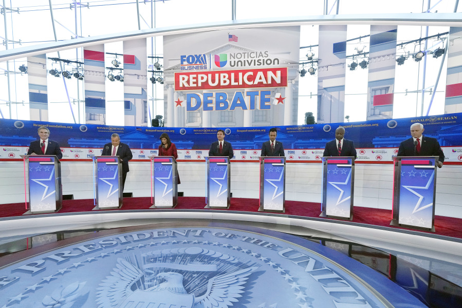 Republican presidential candidates, from left, North Dakota Gov. Doug Burgum, former New Jersey Gov. Chris Christie, former U.N. Ambassador Nikki Haley, Florida Gov. Ron DeSantis, entrepreneur Vivek Ramaswamy, Sen. Tim Scott, R-S.C., and former Vice President Mike Pence, stand at their podiums during a Republican presidential primary debate hosted by FOX Business Network and Univision, Wednesday, Sept. 27, 2023, at the Ronald Reagan Presidential Library in Simi Valley, Calif. (AP Photo/Mark J.