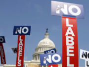 FILE - People with the group No Labels hold signs during a rally on Capitol Hill in Washington, July 18, 2011. More than 15,000 people in Arizona have registered to join a new political party floating a possible bipartisan "unity ticket" against Joe Biden and Donald Trump.
