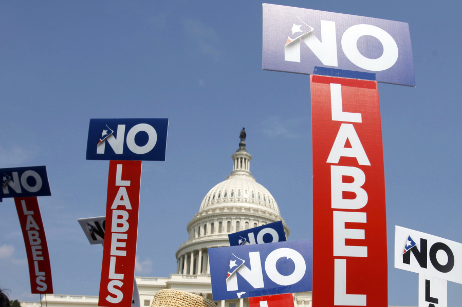 FILE - People with the group No Labels hold signs during a rally on Capitol Hill in Washington, July 18, 2011. More than 15,000 people in Arizona have registered to join a new political party floating a possible bipartisan "unity ticket" against Joe Biden and Donald Trump.