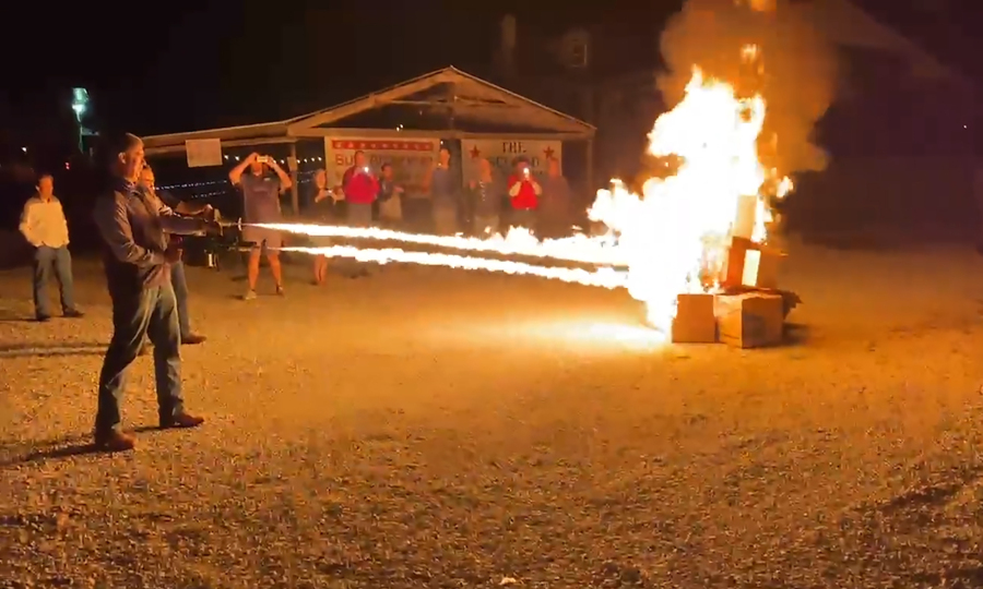 In this frame grab from video provided by Debbie McFarland, state Sen. Bill Eigel torches a pile of cardboard boxes at a "Freedom Fest" event in Defiance, Mo., Sept. 15, 2023. Eigel is a Republican candidate for Missouri governor. After video of Eigel's use of the flamethrower gained attention, Eigel said he'd burn objectionable books if that's what it took to keep them away from children.
