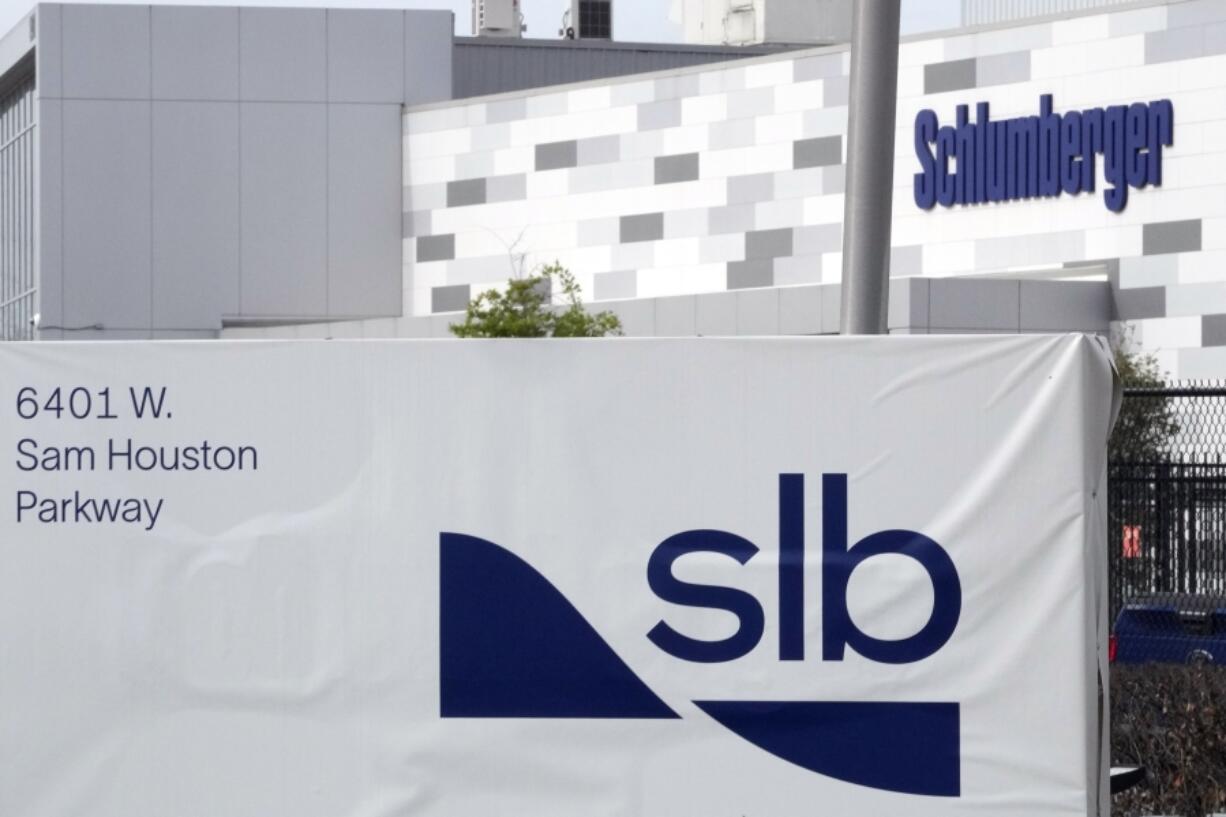 FILE - A sign for SLB, formerly Schlumberger, is displayed at the building on Tuesday, March 21, 2023, in Houston. Sen. Bob Menendez, the head of the U.S. Senate Foreign Relations Committee, asked the country's top three oilfield services companies, including SLB, to explain why they continued doing business in Russia after its invasion of Ukraine, and demanded that they commit to "cease all investments" in Russia's fossil fuel infrastructure. (AP Photo/David J.