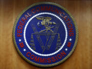 FILE - The seal of the Federal Communications Commission (FCC) is seen before an FCC meeting to vote on net neutrality, Dec. 14, 2017, in Washington. Landmark net neutrality rules rescinded under former President Donald Trump could return under a new push by FCC Chairperson Jessica Rosenworcel. The rules would reclassify broadband access as an essential service on par with other utilities like water or power.