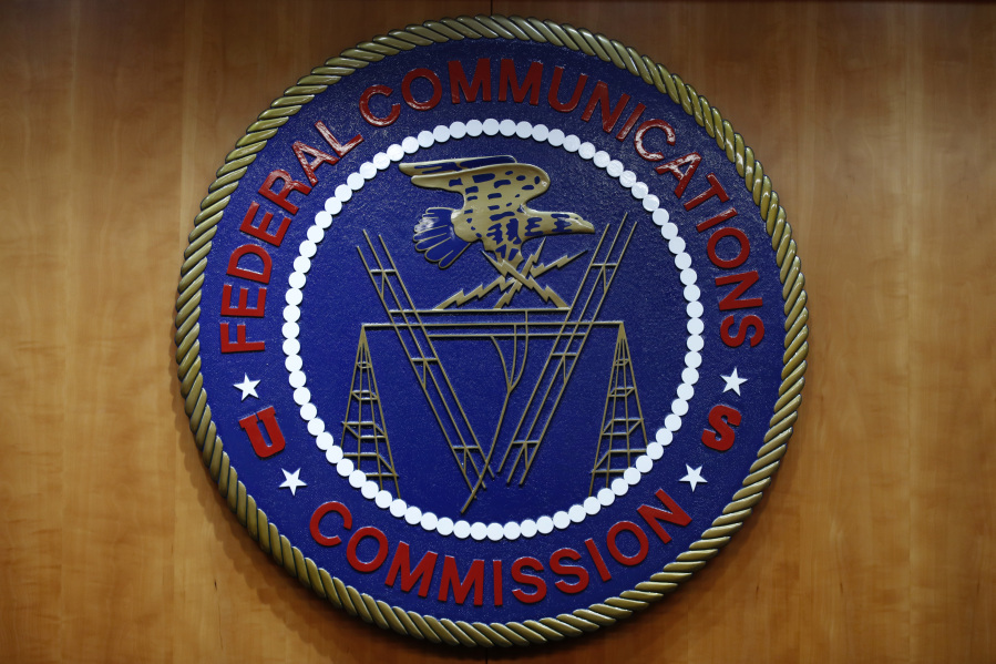 FILE - The seal of the Federal Communications Commission (FCC) is seen before an FCC meeting to vote on net neutrality, Dec. 14, 2017, in Washington. Landmark net neutrality rules rescinded under former President Donald Trump could return under a new push by FCC Chairperson Jessica Rosenworcel. The rules would reclassify broadband access as an essential service on par with other utilities like water or power.