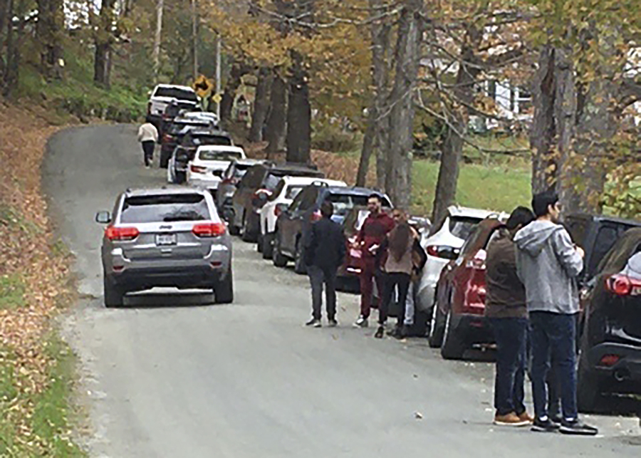 People and cars line a narrow road outside a private property in an undated photo, in Pomfret, Vt., that has become a destination for fall foliage viewers, clogging the rural road. The town is closing the road to leaf peepers through mid-October 2023 because it says the increased traffic has caused significant safety, environmental, aesthetic and quality of life issues.