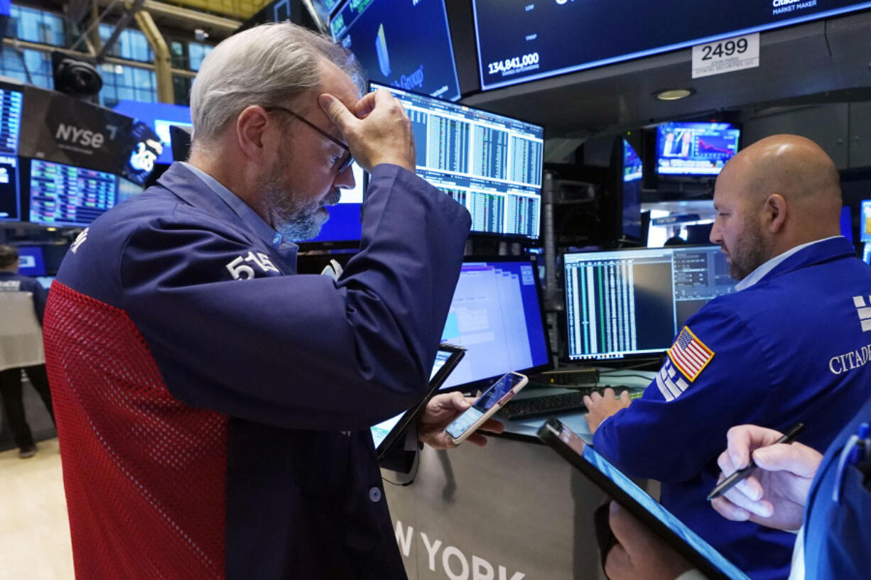 Trader David O'Day, left, and specialist John Parisi work on the floor of the New York Stock Exchange, Wednesday, Sept. 13, 2023. Stocks are churning in place on Wall Street after a highly anticipated report showed inflation accelerated across the country last month, but not by much more than expected.