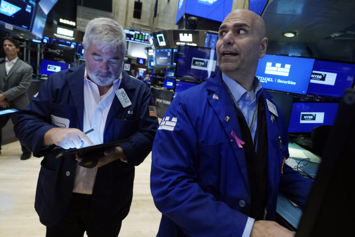 Trader Edward McCarthy, left, and specialist Philip Finale work on the floor of the New York Stock Exchange, Wednesday, Sept. 13, 2023. Stocks are churning in place on Wall Street after a highly anticipated report showed inflation accelerated across the country last month, but not by much more than expected.