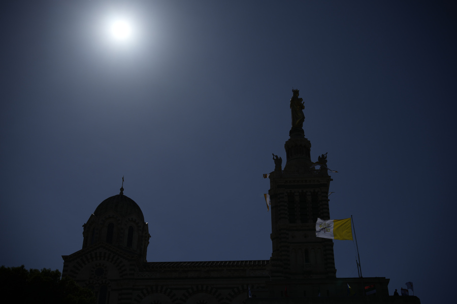 A Vatican Flag waves near the Notre Dame de la Garde Basilica in Marseille, southern France, the day Pope Francis arrives for a two-day visit, Friday, Sept. 22, 2023, when he will join Catholic bishops from the Mediterranean region on discussions that will largely focus on migration.