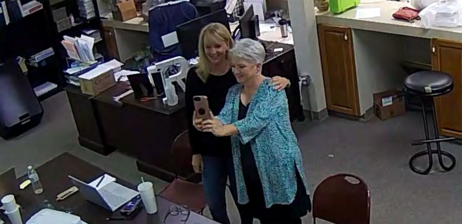 FILE - In this Jan. 7, 2021, image taken from Coffee County, Ga., security video, Cathy Latham, right, appears to take a selfie with a member of a computer forensics team inside the local elections office.