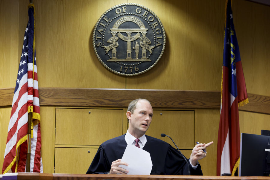 FILE - Fulton County Superior Court Judge Scott McAfee hears motions from attorneys representing Kenneth Chesebro and Sidney Powell in Atlanta on Thursday, Sept. 14, 2023. Past high-profile trials suggest additional scrutiny and stress for the four judges overseeing the indictments against former President Donald Trump. But the challenge facing Fulton County Judge Scott McAfee in Georgia is unlike any of the others.