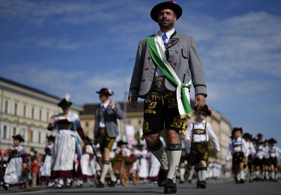 People in traditional Bavarian costumes march during a traditional costume and riflemen's parade at the second day of the 188th 'Oktoberfest' beer festival in Munich, Germany, on Sunday.