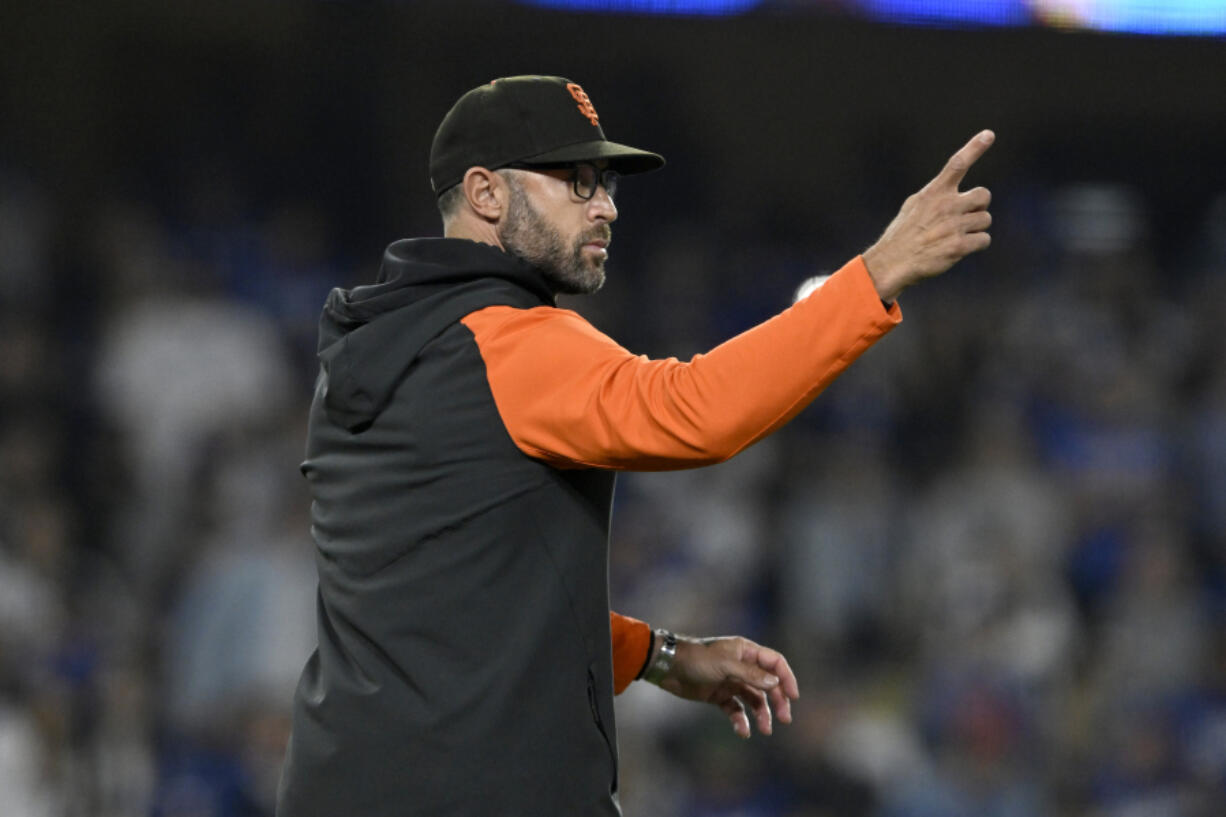 San Francisco Giants manager Gabe Kapler points to the bullpen, calling for relief pitcher Camilo Doval during the eighth inning of the team's baseball game against the Los Angeles Dodgers in Los Angeles, Friday, Sept. 22, 2023.