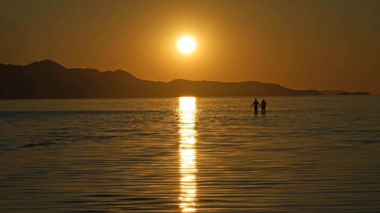 FILE - The sun sets on the Great Salt Lake on June 15, 2023, near Magna, Utah. A coalition of environmental organizations sued the state of Utah on Wednesday, Sept. 6, 2023, based on accusations that it is not doing enough make sure enough water gets to the shrinking Great Salt Lake.