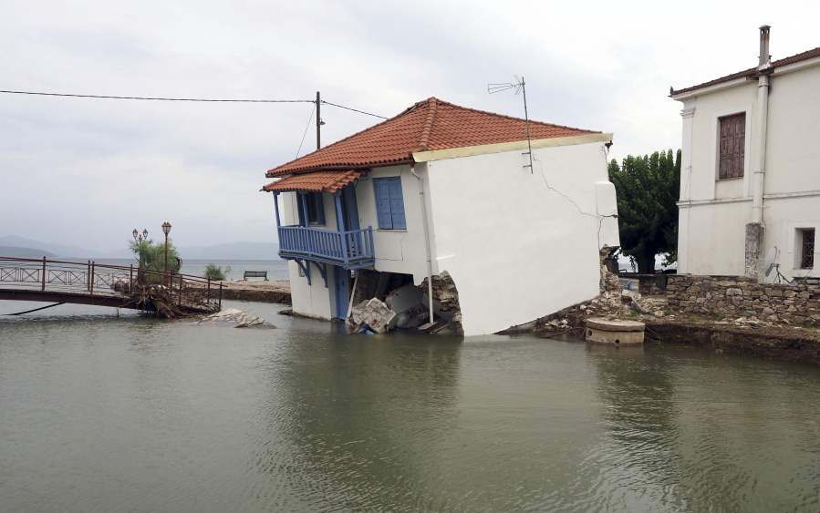 A damaged house stands over the water after the country's record rainfall in Horto village, Pilion region, central Greece, Wednesday, Sept. 6, 2023. Rescue teams in Turkey, Greece and Bulgaria have recovered more bodies following floods after fierce rainstorms.
