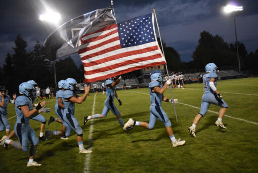 Members of the Hockinson football team take the field prior to their game against R.A. Long at Hockinson High School on Thursday, Sept. 21, 2023.