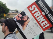 Picketers rally outside the Warner Bros., studios in Burbank, Calif., Thursday, Sep. 21, 2023.