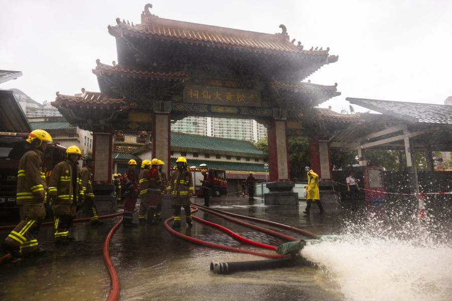 Fire-fighters drain out water following heavy rainstorms in Hong Kong, Friday, Sept. 8, 2023. Rain pouring onto Hong Kong and southern China overnight flooded city streets and some subway stations, halting transportation and forcing schools to close Friday.