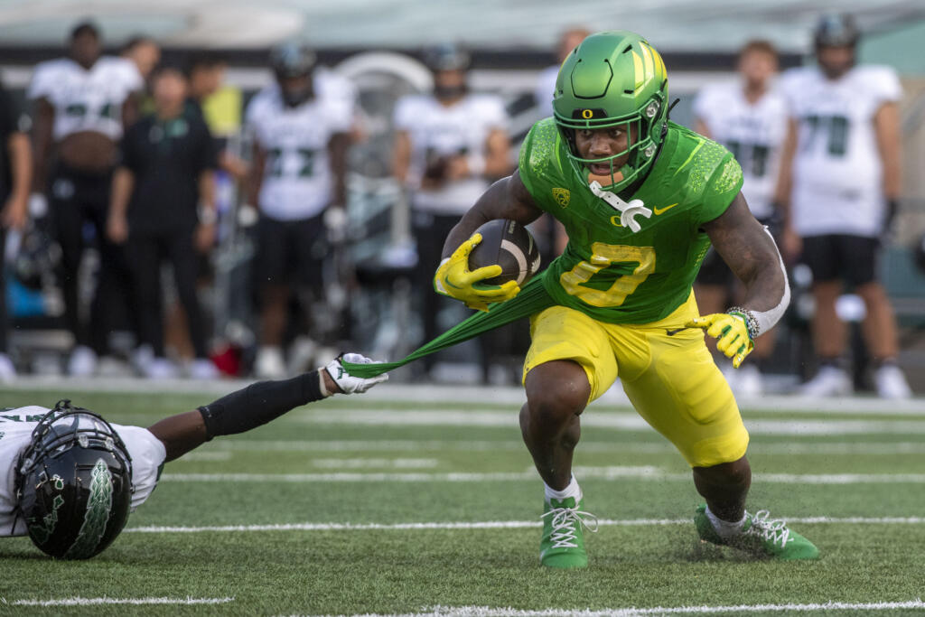 Hawaii defensive back Caleb Brown slows down Oregon running back Bucky Irving (0) during the first half of an NCAA college football game Saturday, Sept. 16, 2023, in Eugene, Ore.