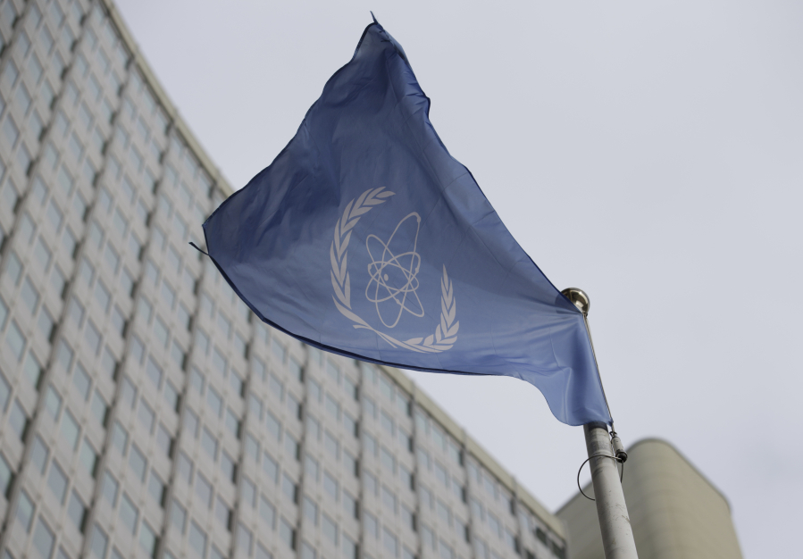 FILE - The flag of the International Atomic Energy Agency flies in front of its headquarters during an IAEA Board of Governors meeting in Vienna, Austria, Monday, Feb. 6, 2023. Iran has slowed its enrichment of uranium at nearly weapons-grade levels, a report by the United Nations' nuclear watchdog seen by The Associated Press said Monday, Sept. 4, 2023.