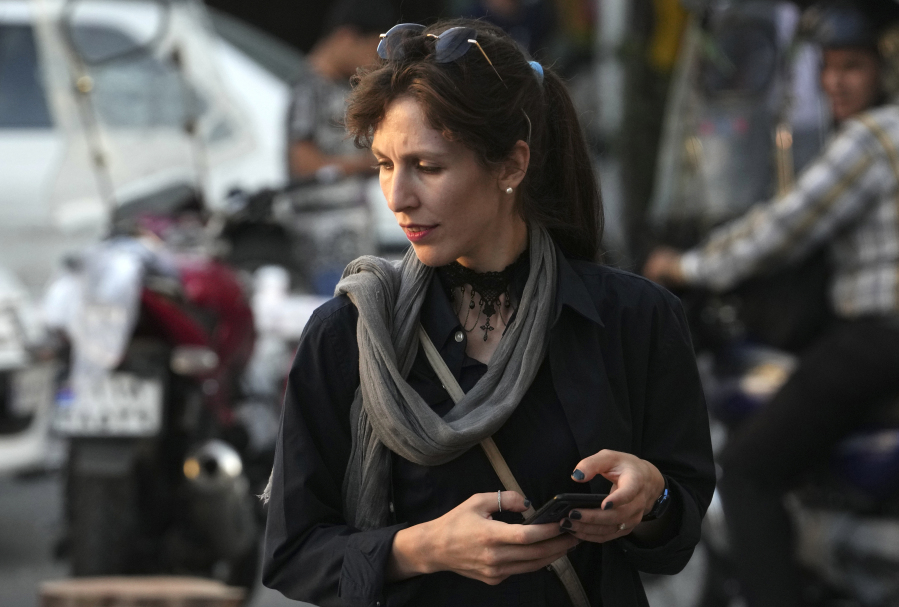 An Iranian woman without wearing her mandatory Islamic headscarf walks in downtown Tehran, Iran, Saturday, Sept. 9, 2023. Iranians are marking the first anniversary of nationwide protests over the country's mandatory headscarf law that erupted after the death of a young woman detained by morality police.