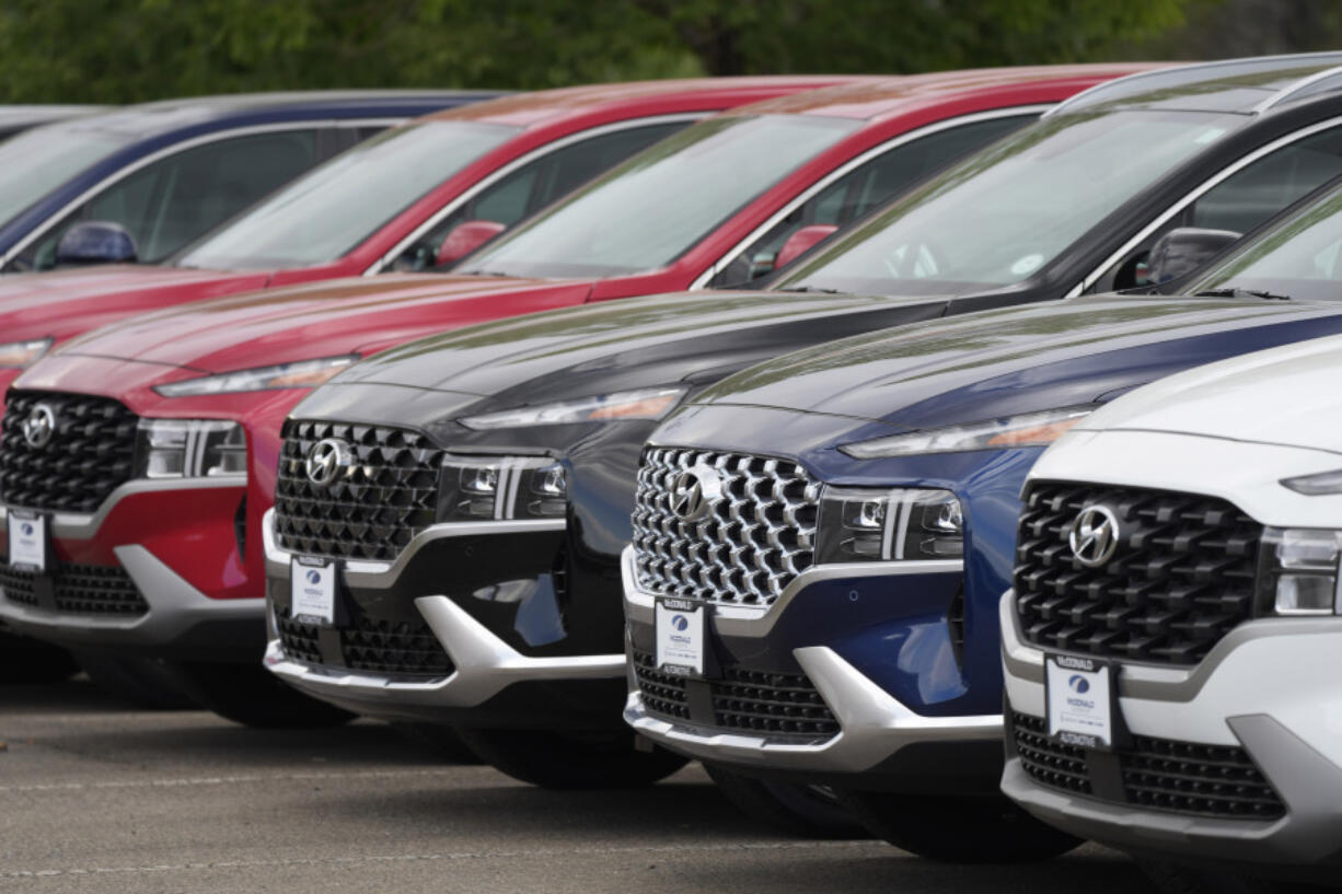 FILE - A line of 2022 Santa Fe SUV's sit outside a Hyundai dealership on Sept. 12, 2021, in Littleton, Colo. Nearly 3.4 million Hyundai and Kia vehicles in the U.S. are under recall due to the risk of engine compartment fires.