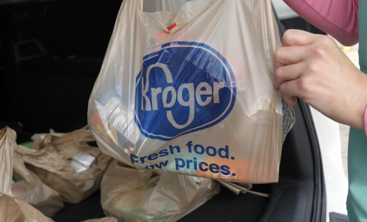 FILE - A customer removes her purchases at a Kroger grocery store in Flowood, Miss., Wednesday, June 26, 2019.   Kroger and Albertsons are selling more than 400 stores and other assets to C&S Wholesale Grocers in an approximately $1.9 billion deal as part of their efforts to complete their merger, Friday, Sept. 8, 2023. (AP Photo/Rogelio V.