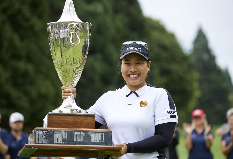 Chanettee Wannasaen, of Thailand, holds the trophy after winning the LPGA Portland Classic golf tournament in Portland, Ore., Sunday, Sept. 3, 2023.