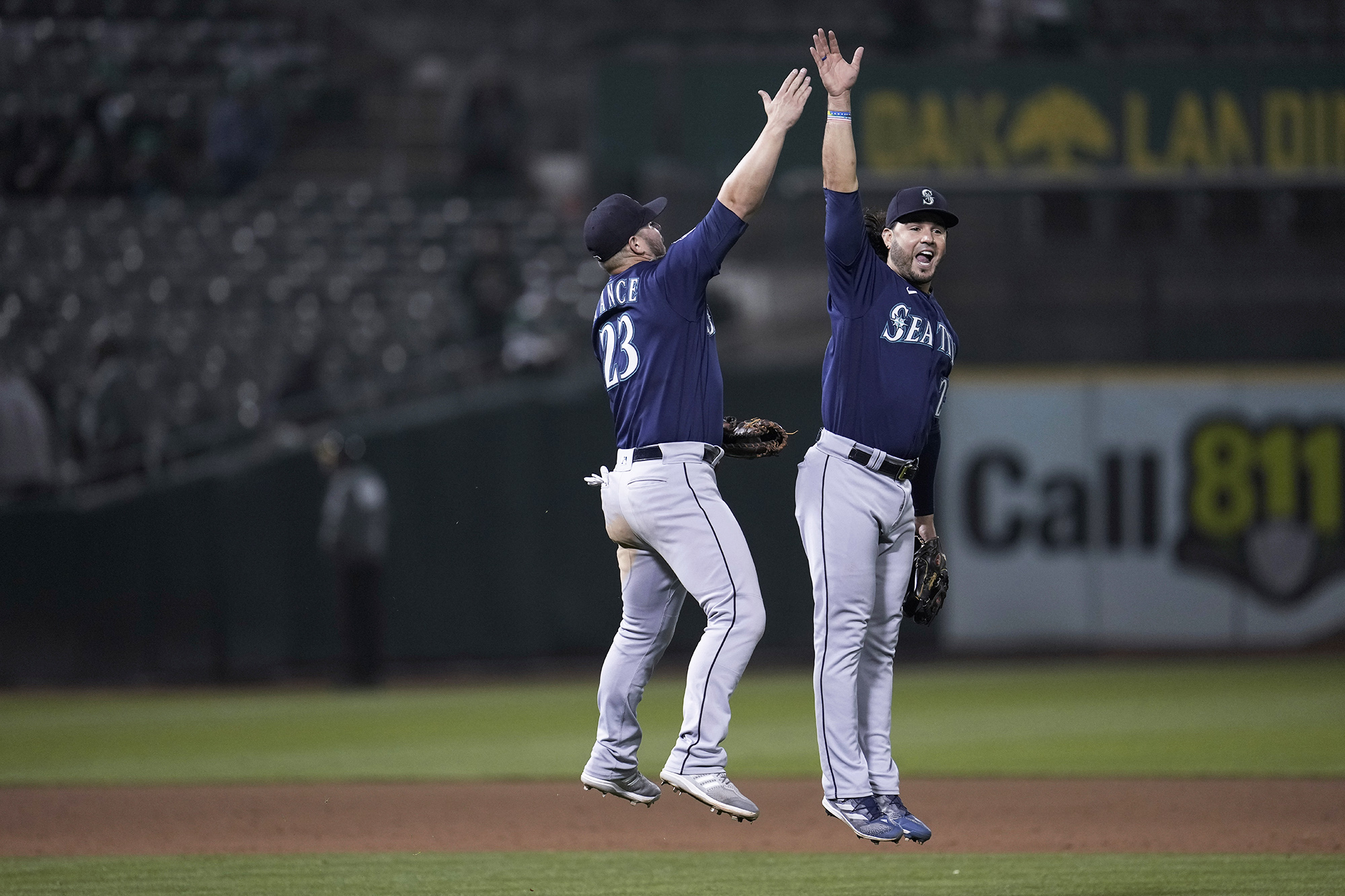 Seattle Mariners first baseman Ty France, left, and third baseman Eugenio Suárez celebrate the team's 7-2 victory over the against the Oakland Athletics in a baseball game Tuesday, Sept. 19, 2023, in Oakland, Calif. (AP Photo/Godofredo A.