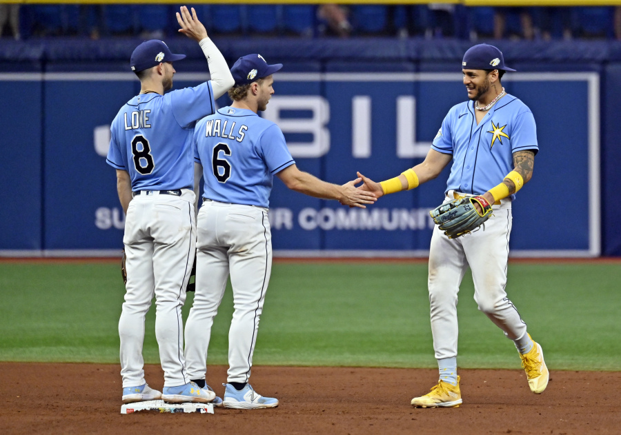 Tampa Bay Rays Brandon Lowe (8), Taylor Walls (6) and Jose Siri celebrate their team's over the Seattle Mariners during a baseball game, Sunday, Sept. 10, 2023, in St. Petersburg, Fla.