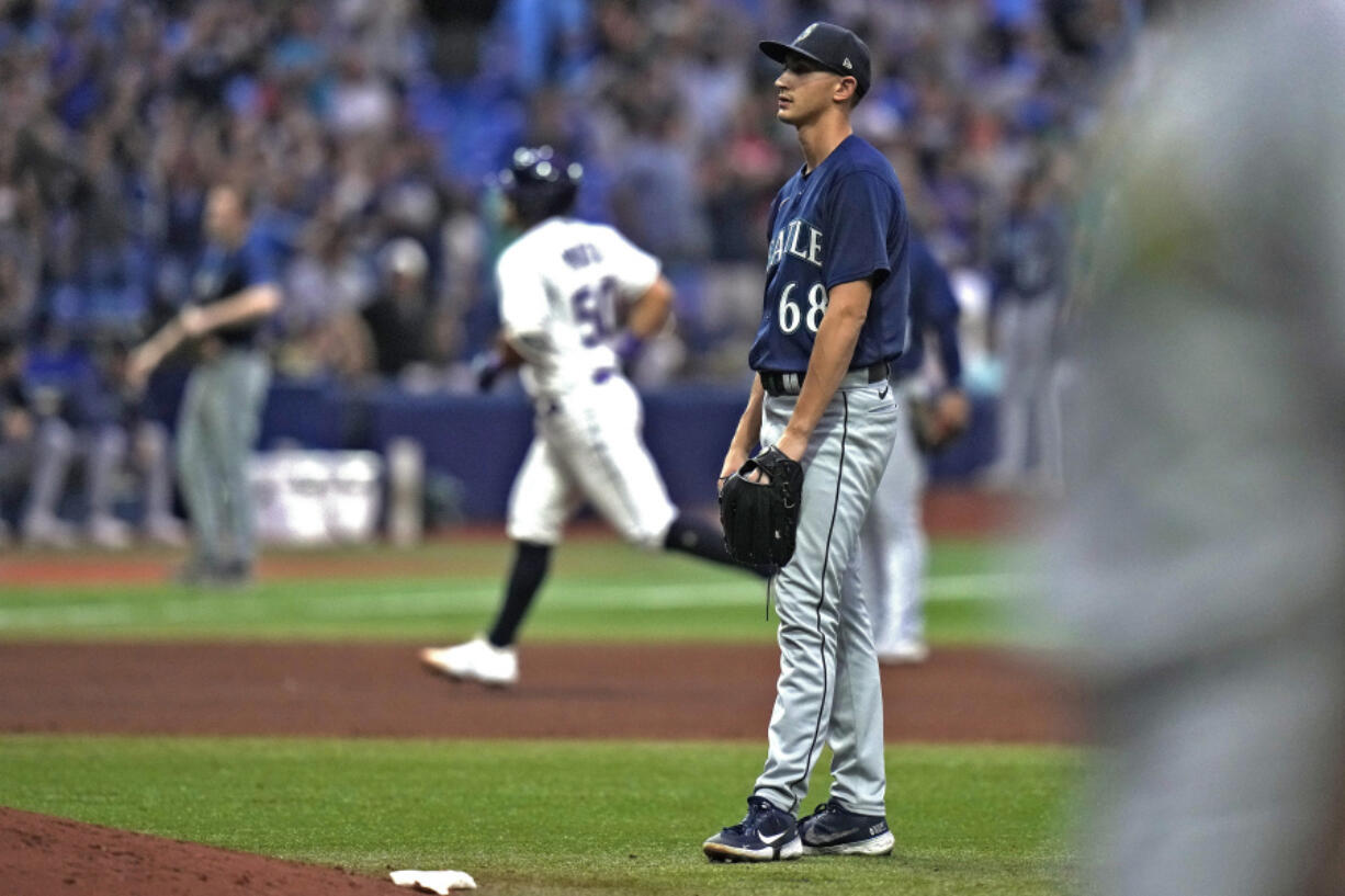 Seattle Mariners starting pitcher George Kirby (68) reacts as Tampa Bay Rays' Rene Pinto (50) runs around the bases after his two-run home run during the seventh inning of a baseball game Friday, Sept. 8, 2023, in St. Petersburg, Fla.