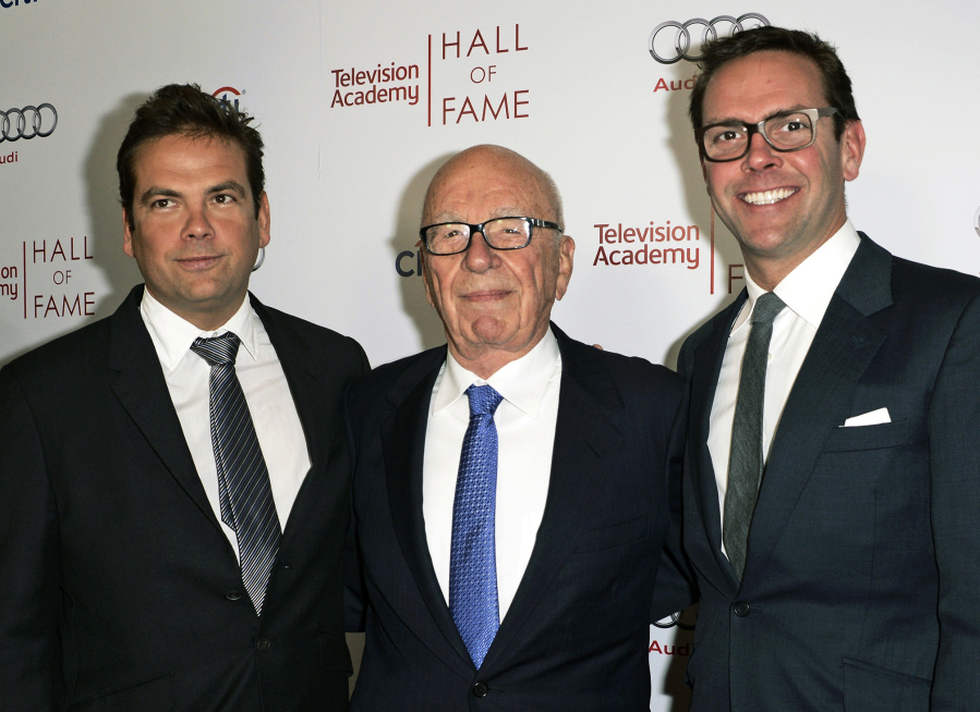 FILE - News Corp. Exeuctive Chairman Rupert Murdoch, center, and his sons, Lachlan, left, and James Murdoch attend the 2014 Television Academy Hall of Fame in Beverly Hills, Calif, March 11, 2014. Media magnate Rupert Murdoch is stepping down as chairman of News Corp. and Fox Corp., the companies that he built into forces over the last 50 years. He will become chairman emeritus of both corporations, the company announced on Thursday. His son, Lachlan, will control both companies.