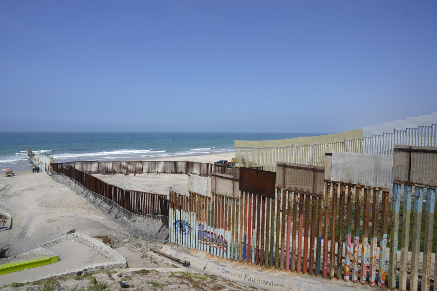 Construction continues on the border wall that separate the United States from Mexico, as seen from Tijuana, Mexico, Friday, Aug. 25, 2023. As the U.S. government built its latest stretch of border wall, Mexico made a statement of its own by laying remains of the Berlin Wall a few steps away.