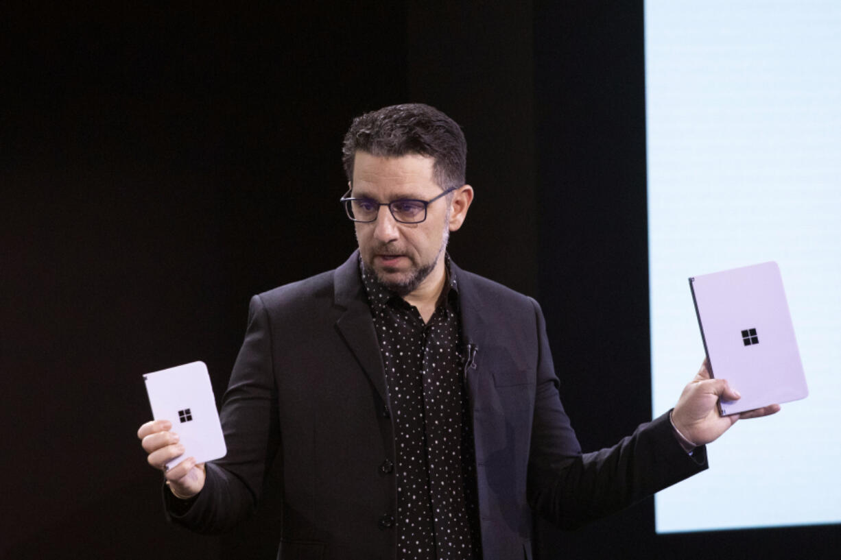 FILE - Microsoft's Chief Product Officer Panos Panay holds a Surface Duo, left, and Surface Neo at an event, Wednesday, Oct. 2, 2019, in New York. Panos Panay is stepping down after nearly 20 years at Microsoft, according to a staff memo Monday, Sept. 18, 2023.