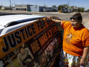Blossom Old Bull holds up a banner for her son which says "justice for Braven Glenn," during a rally in support of the Missing and Murdered Indigenous People movement at the Big Horn County Building on Tuesday, Aug. 29, 2023, in Hardin, Mont. Glenn was killed while being pursued by a Crow Tribal Police officer. The Crow Tribal Police Department has since been disbanded and Old Bull has been critical of the amount of information she has received regarding the circumstances of her son's death.