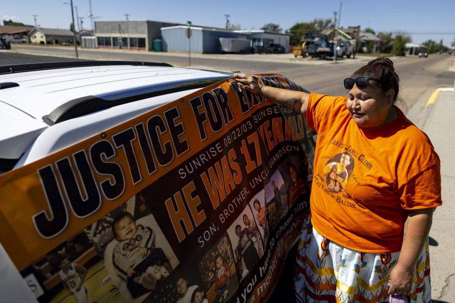 Blossom Old Bull holds up a banner for her son which says "justice for Braven Glenn," during a rally in support of the Missing and Murdered Indigenous People movement at the Big Horn County Building on Tuesday, Aug. 29, 2023, in Hardin, Mont. Glenn was killed while being pursued by a Crow Tribal Police officer. The Crow Tribal Police Department has since been disbanded and Old Bull has been critical of the amount of information she has received regarding the circumstances of her son's death.