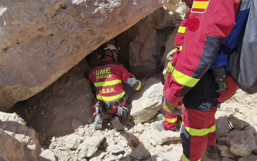 In this photo made available by UME (Military Emergency Unit), members of the UME unit search for survivors under a collapsed building near Khair Anougal, Morocco, Monday, Sept. 11, 2023.