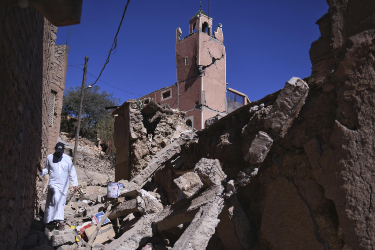A man walks amid the rubble in front of a damaged mosque in Moulay Brahim in the province of Al Haouz, Morocco, Sunday Sept. 10, 2023. An aftershock rattled Moroccans on Sunday as they prayed for victims of the nation's strongest earthquake in more than a century and toiled to rescue survivors while soldiers and workers brought water and supplies to desperate mountain villages in ruins.
