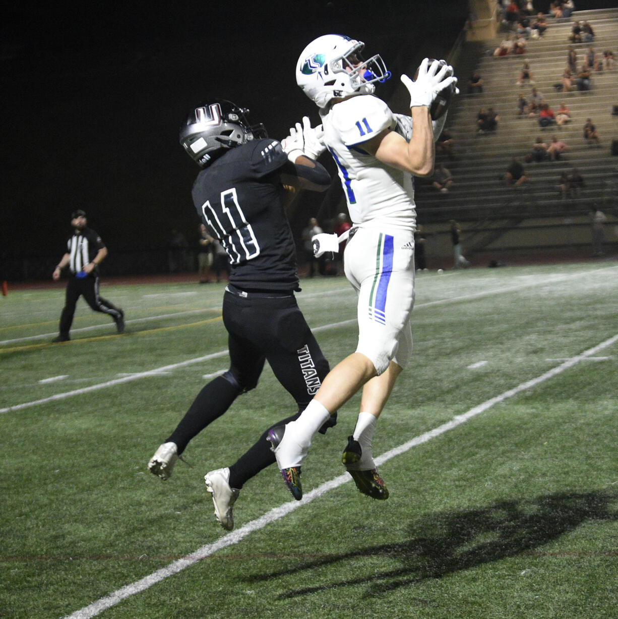 Mountain View’s Aiden Nicholson (11) makes a catch in front of Union’s Jordan Warren during Mountain View’s 42-27 wi over Union at McKenzie Stadium on Friday, Sept. 15, 2023.