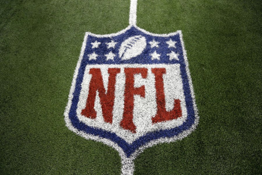 FILE - An NFL logo on the field after a football game between the Washington Redskins and Dallas Cowboys Sunday, Oct. 13, 2013, in Arlington, Texas. The NFL is making additional moves to reach more fans with direct-to-consumer offerings. The league announced on Wednesday, Aug. 9, 2023, that NFL Network and NFL RedZone will be available on "NFL+," the streaming service the league launched last year.