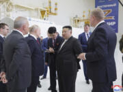 In this photo provided by the North Korean government, Russian President Vladimir Putin, third left, and North Korean leader Kim Jong Un, center, visit the Vostochny cosmodrome outside the city of Tsiolkovsky, about 200 kilometers (125 miles) from the city of Blagoveshchensk in the far eastern Amur region, Russia, Wednesday, Sept. 13, 2023. Independent journalists were not given access to cover the event depicted in this image distributed by the North Korean government. The content of this image is as provided and cannot be independently verified. Korean language watermark on image as provided by source reads: "KCNA" which is the abbreviation for Korean Central News Agency.