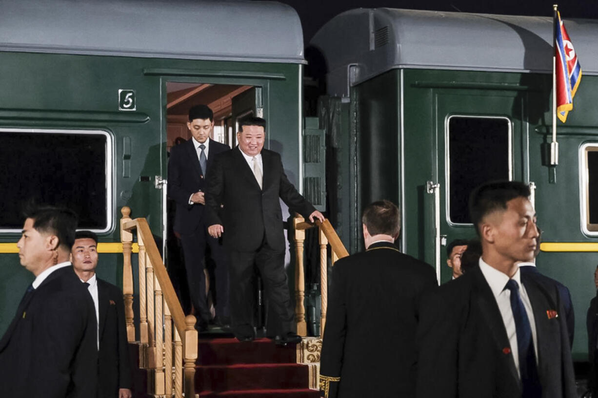 In this photo taken from video released by Russian Ministry of Natural Resources and Ecology telegram channel on Tuesday, Sept. 12, 2023, North Korea's leader Kim Jong Un, center, steps down from his train after crossing the border to Russia at Khasan, about 127 km (79 miles) south of Vladivostok. North Korea's Kim Jong Un rolled into Russia on an armored train to see President Vladimir Putin.