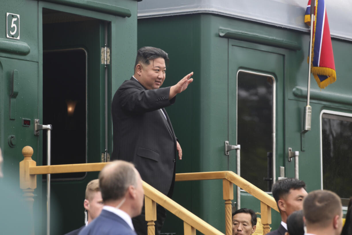 In this photo released by Government of Primorsky Krai Region, North Korea's leader Kim Jong Un waves as he boards his train prior to leaving Artyom, near Vladivostok, Russian Far East on Sunday, Sept. 17, 2023.