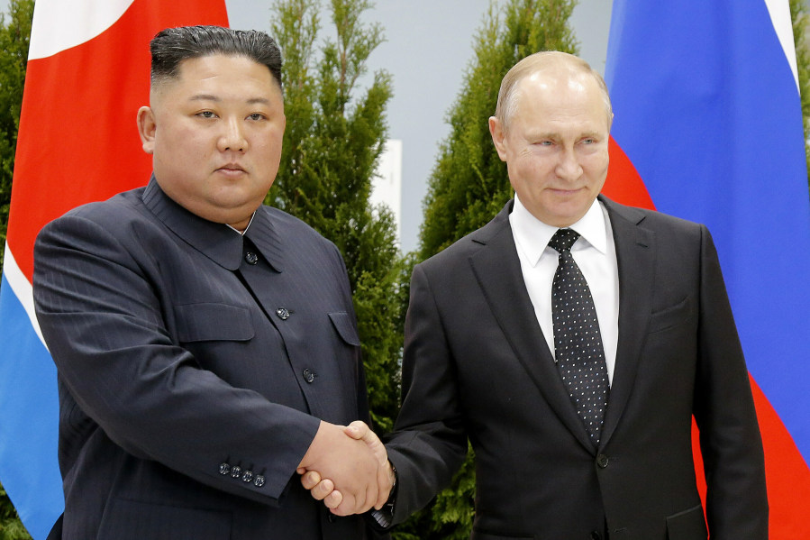 FILE - Russian President Vladimir Putin, right, and North Korea's leader Kim Jong Un shake hands during their meeting in Vladivostok, Russia on April 25, 2019. Kim may travel to Russia for a summit with Putin, a U.S. official said, in a trip would underscore deepening cooperation as the two leaders are locked in separate confrontations with the U.S.