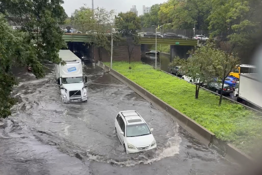 In this photo taken from video, traffic makes its way through flood waters along the Brooklyn Queens Expressway , Friday, Sept. 29, 2023, in New York. A potent rush-hour rainstorm has swamped the New York metropolitan area. The deluge Friday shut down swaths of the subway system, flooded some streets and highways, and cut off access to at least one terminal at LaGuardia Airport.